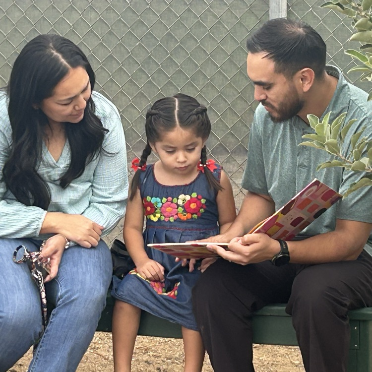 Parents reading to child