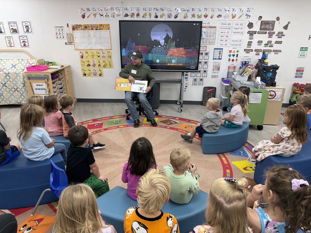 Guest reader reading to elementary students.