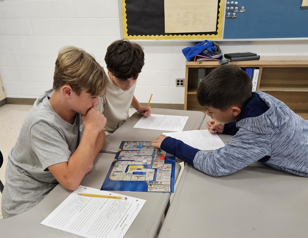 Three JH boys playing a board game.