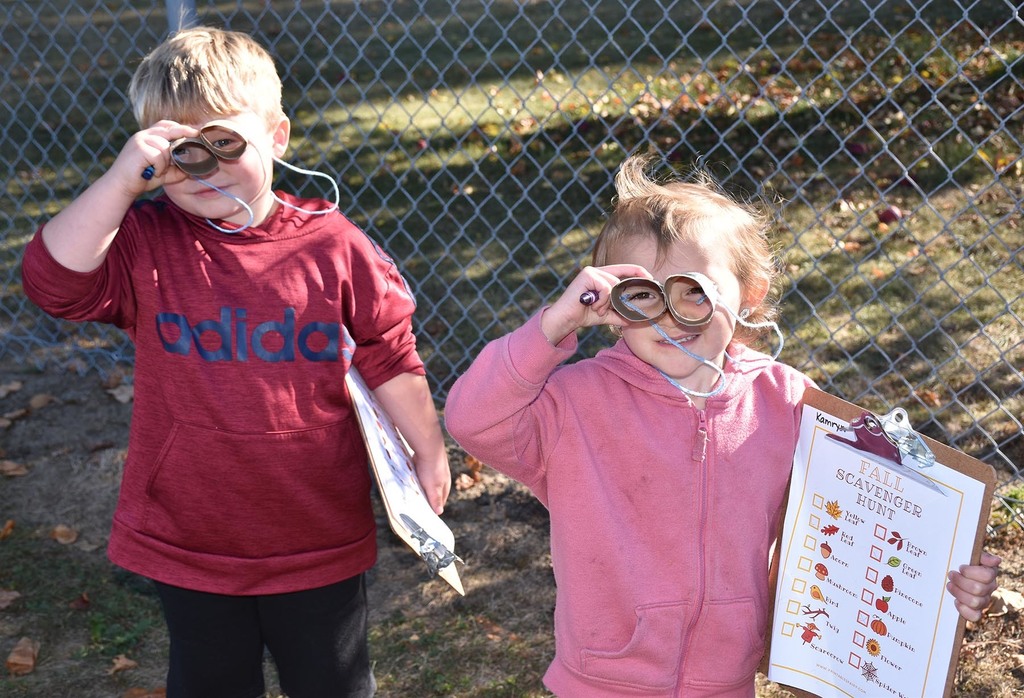 An elementary boy and girl looking through homemade binoculars. 