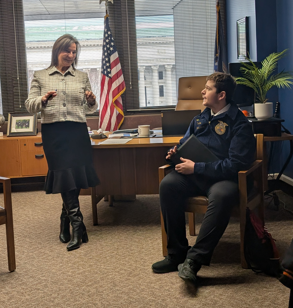 A Perry FFA student speaking with Assemblywoman Andrea Bailey. 