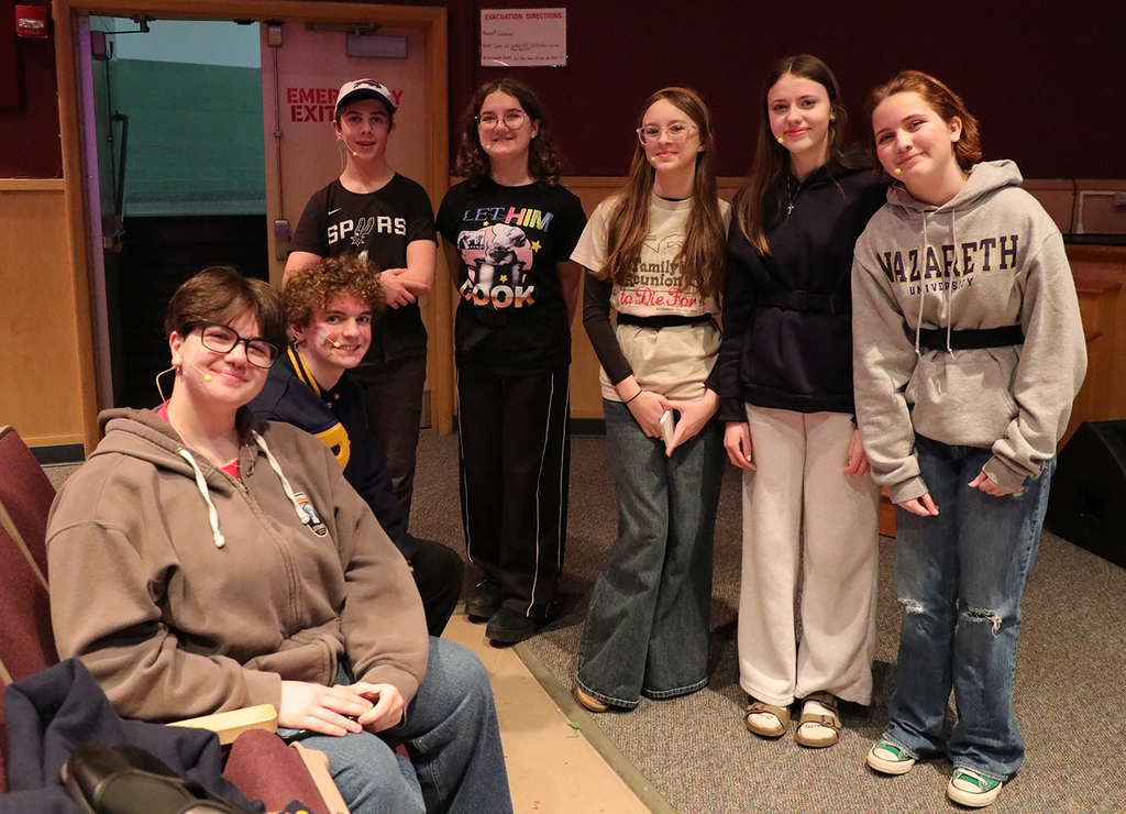 A group of high school students in a school auditorium. 