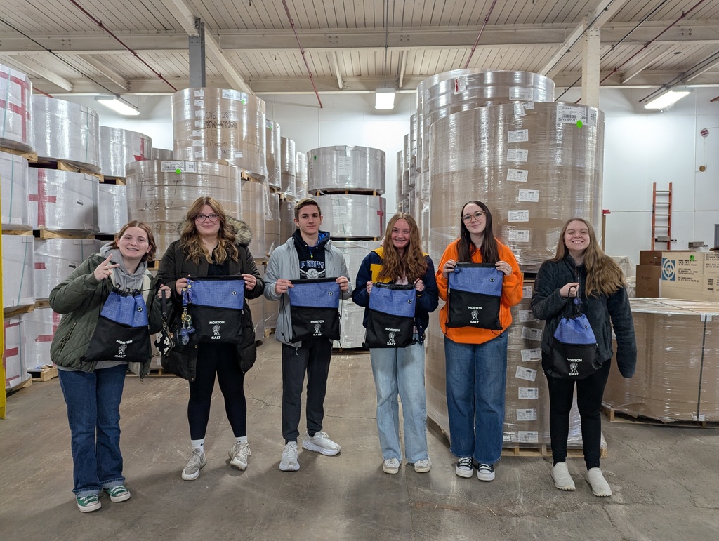 A group of students standing in a manufacturing location. 