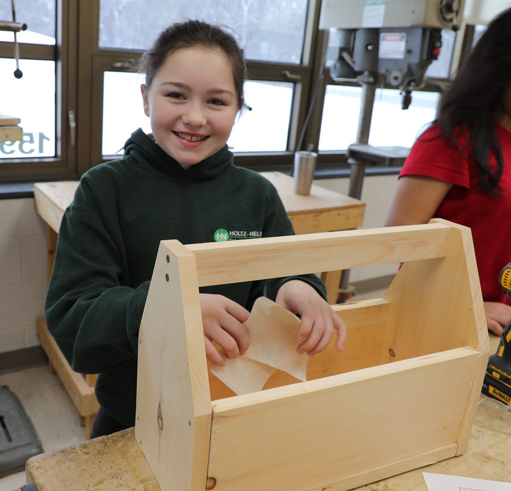 A 5th grade girl smiling. 