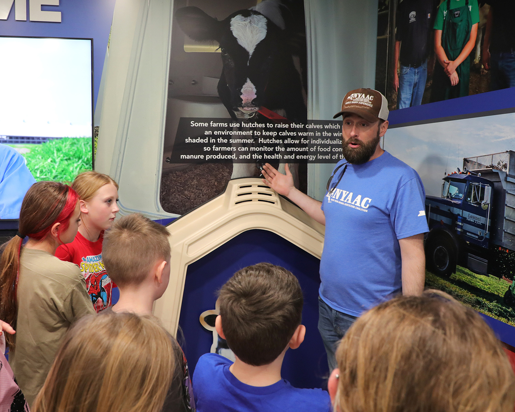 Students gathered around an adult. 