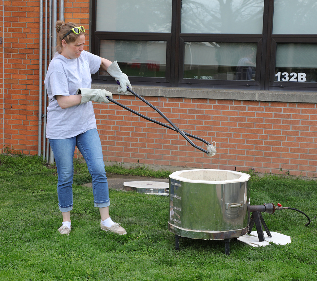 A teacher raku firing outside. 