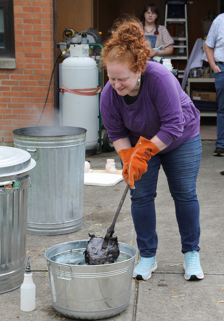 A teacher raku firing outside. 