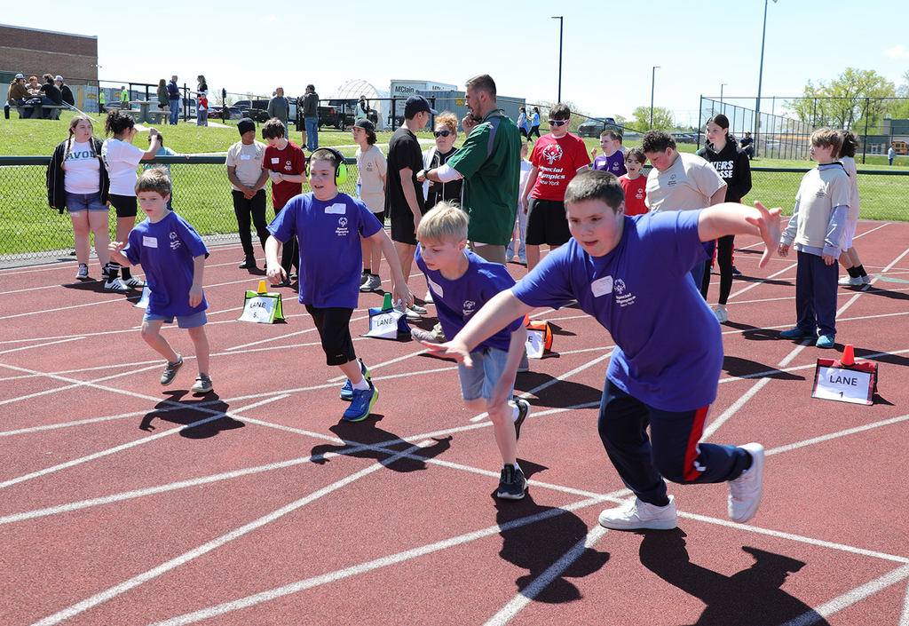 Students running in a race on a track. 