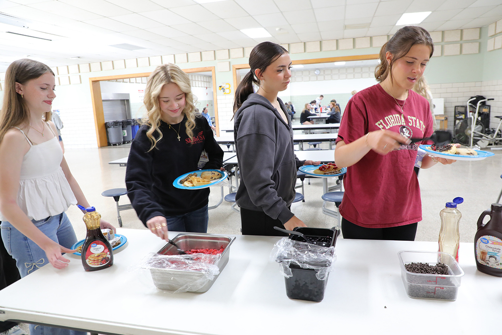 High school students at a waffle station. 