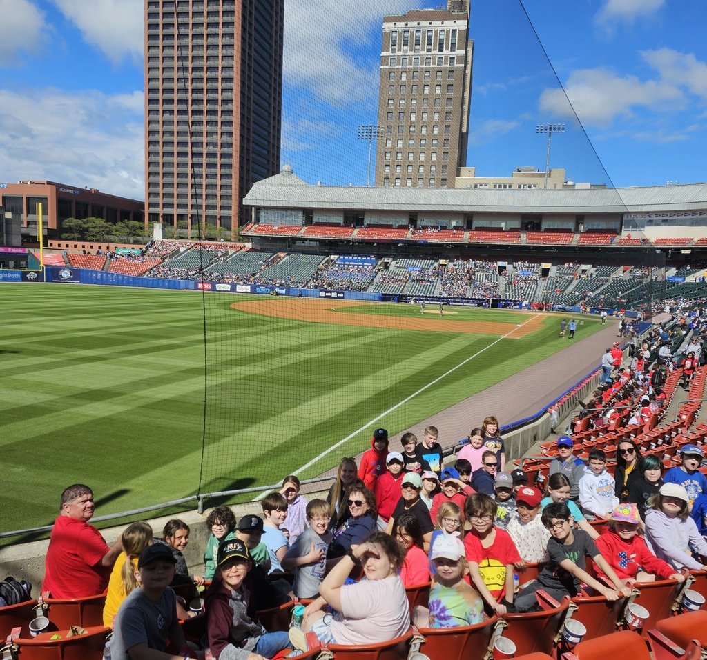 A group of students at a baseball field.