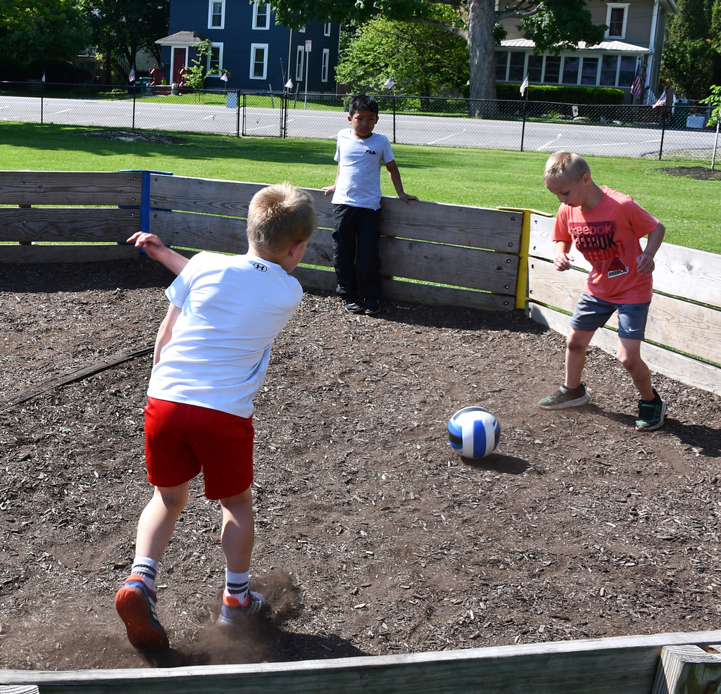 Three boys playing at a park. 
