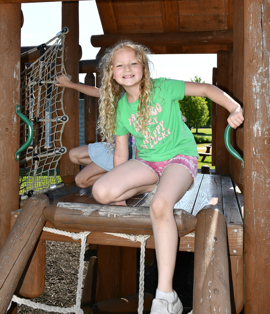 A girl playing on a playground. 