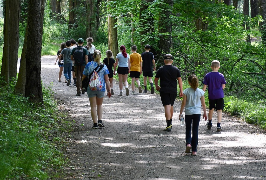 A group of students walking in a state park. 