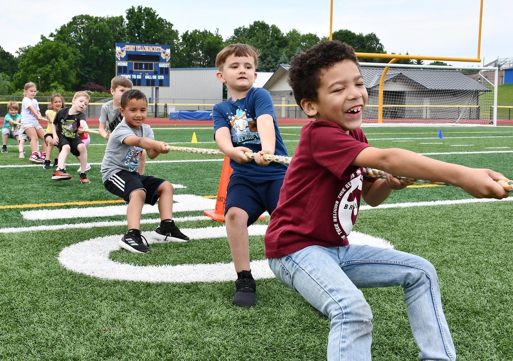 Elementary students competing in tug of war. 