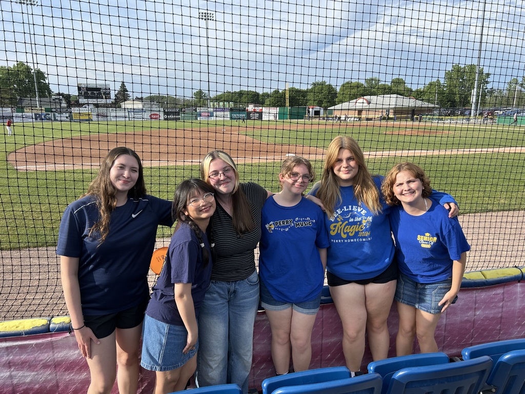 A group of teenagers at a baseball game. 