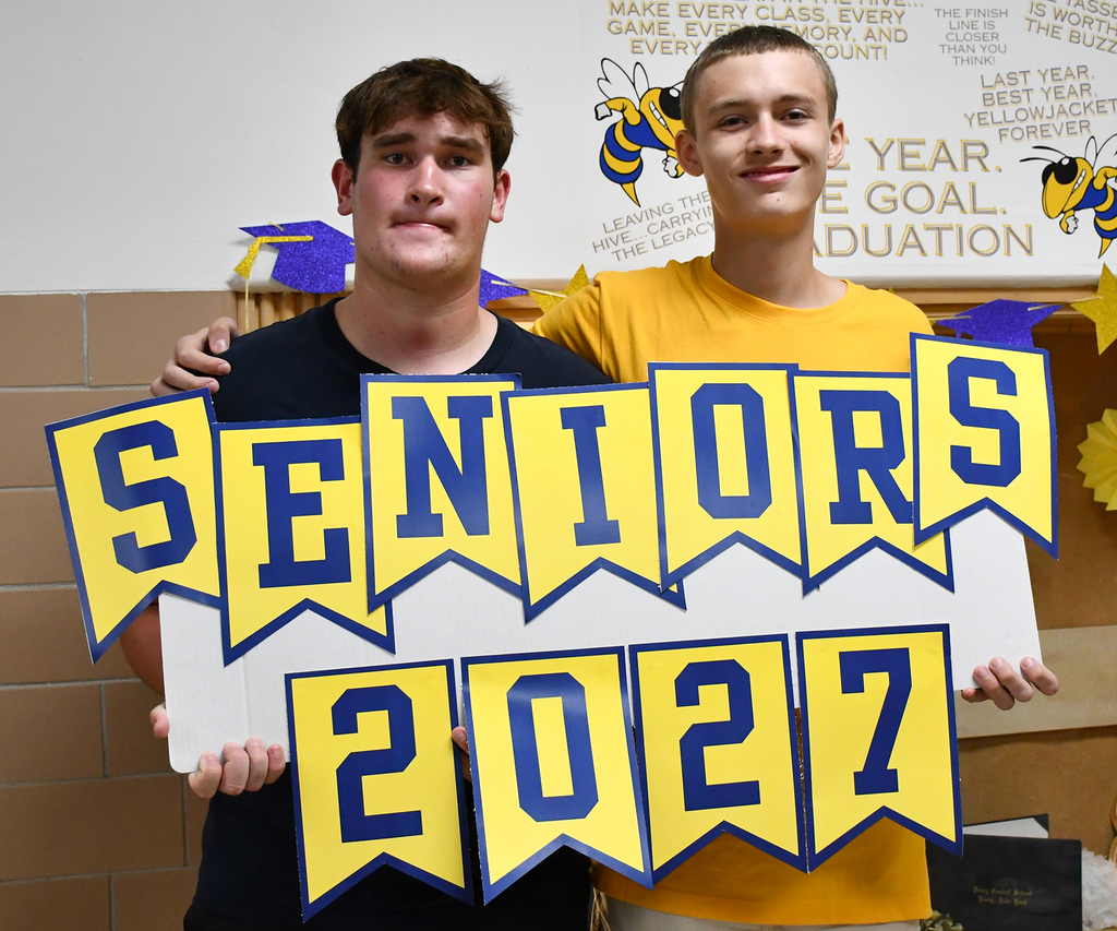 Two boys holding a "Seniors 2027" sign. 