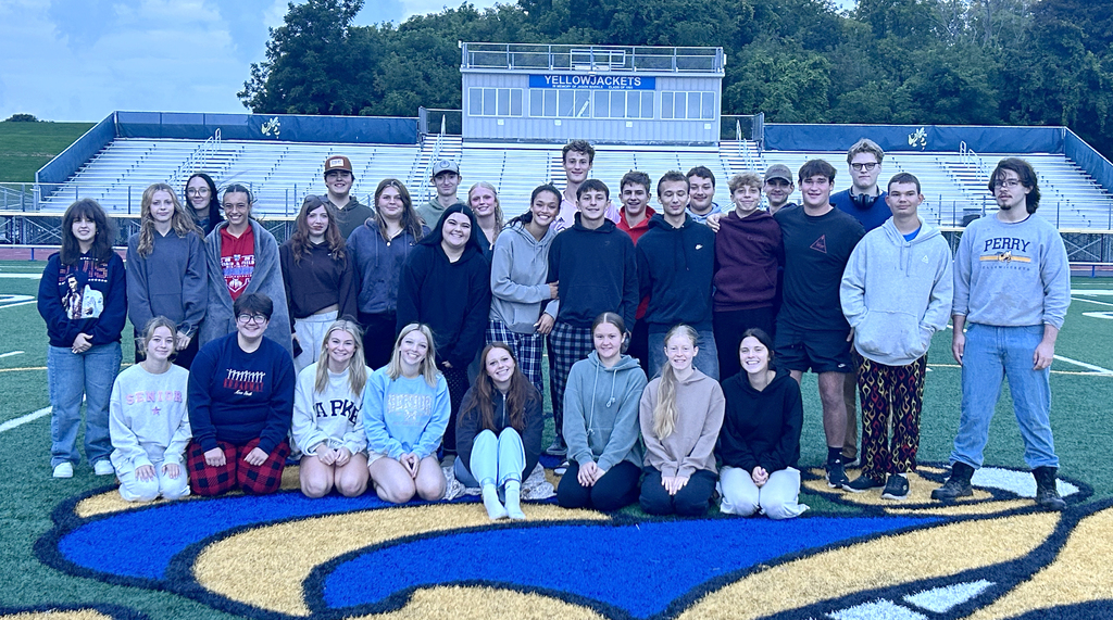 A group of seniors on a football field.