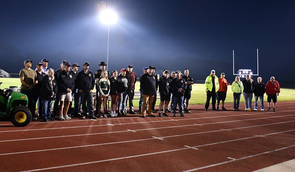A group of people on a football field. 