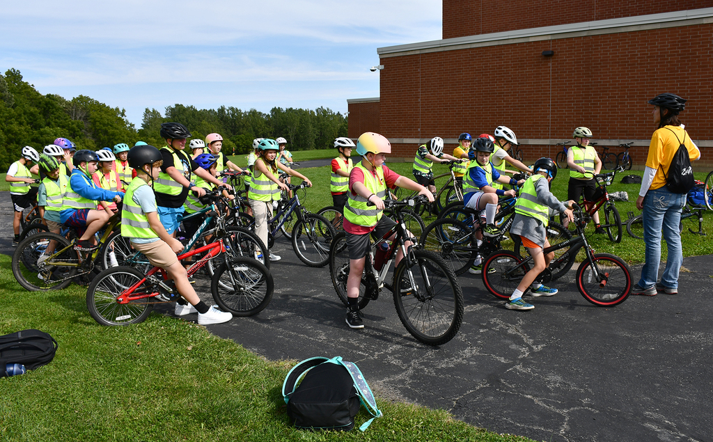 A group of elementary students on bikes. 