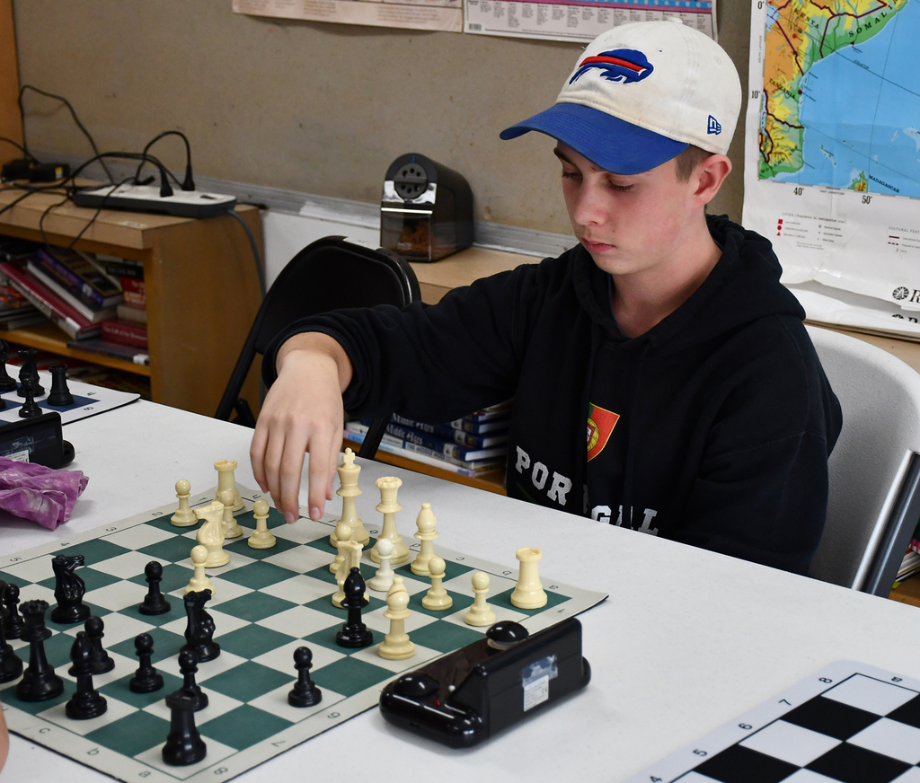 A high school student playing chess. 