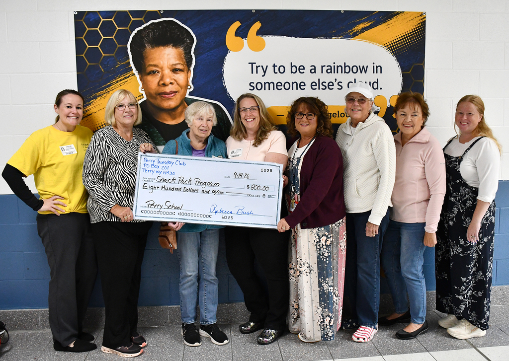 A group of women holding a giant check. 