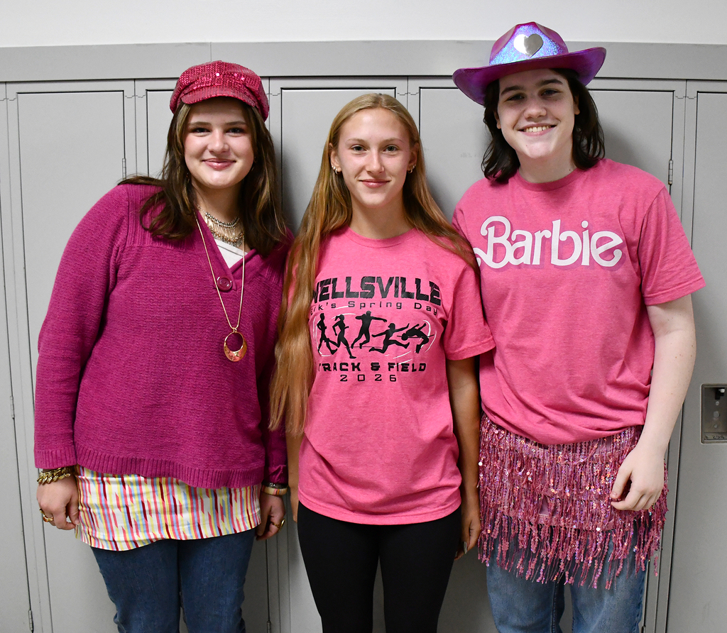 Three high school students dressed in pink. 