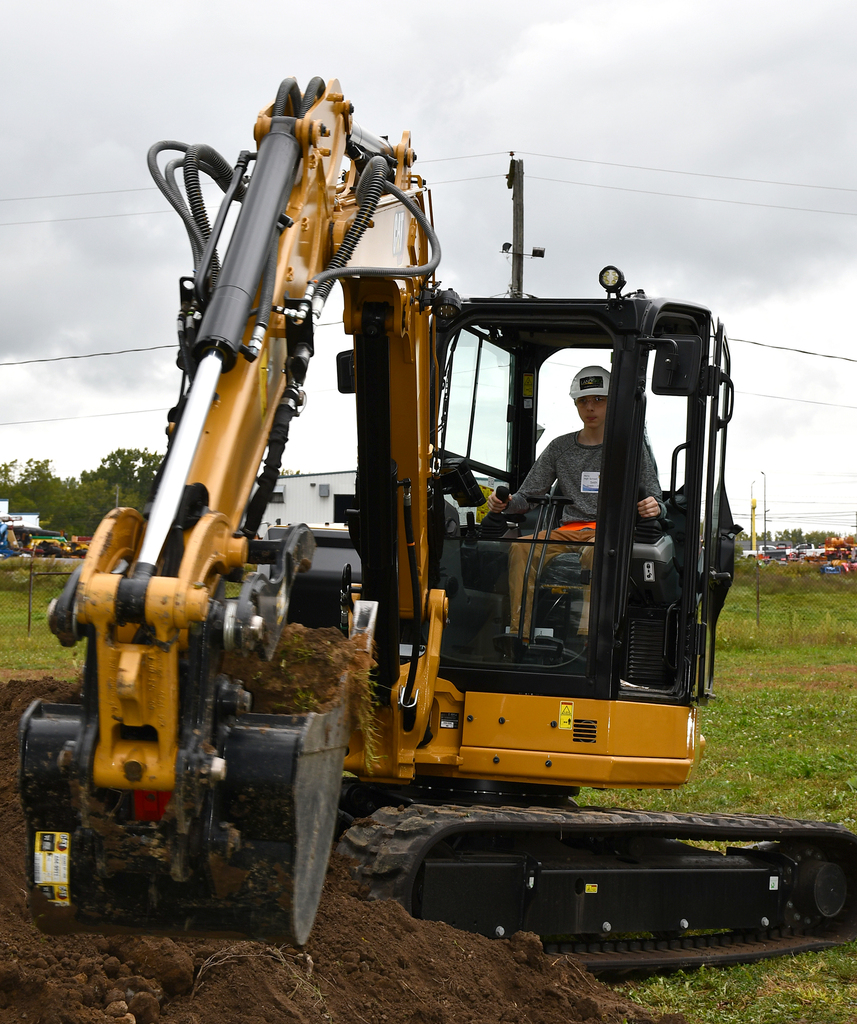 A student operating an excavator. 