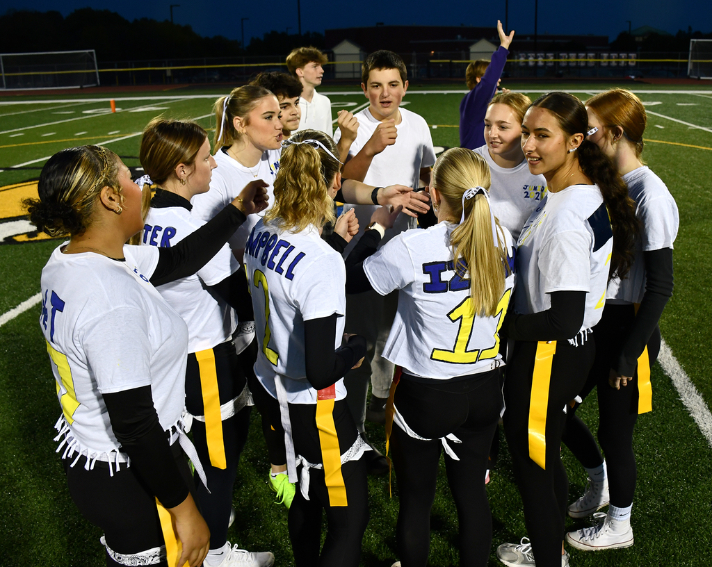 A team cheering on a football field. 