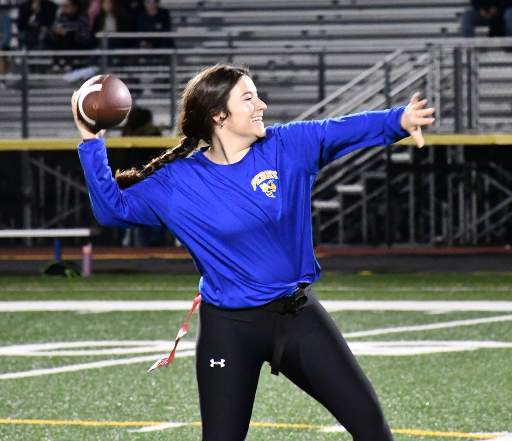 A girl throwing a football.