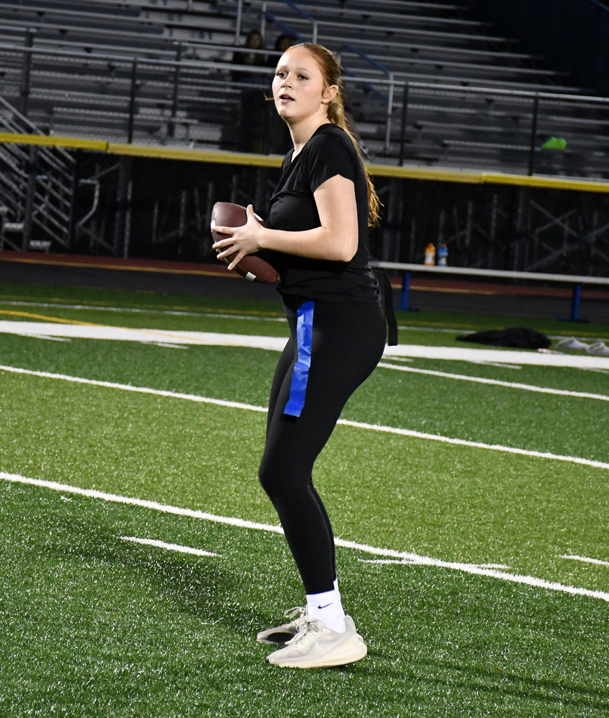 A girl throwing a football. 
