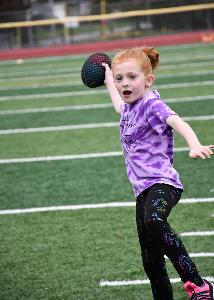 A girl throwing a football. 