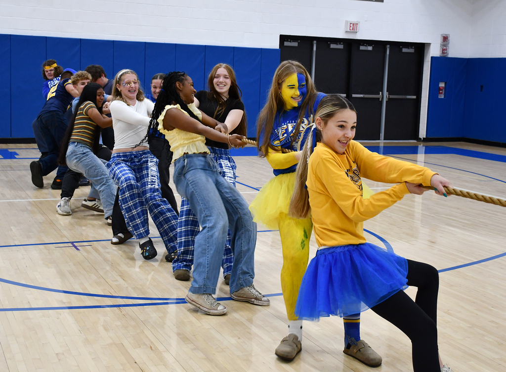 A group of students competing in a tug of war. 