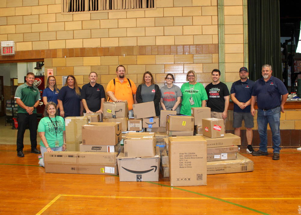 Staff from TG and Perryville High School along with boxes of supplies donated to PHS.