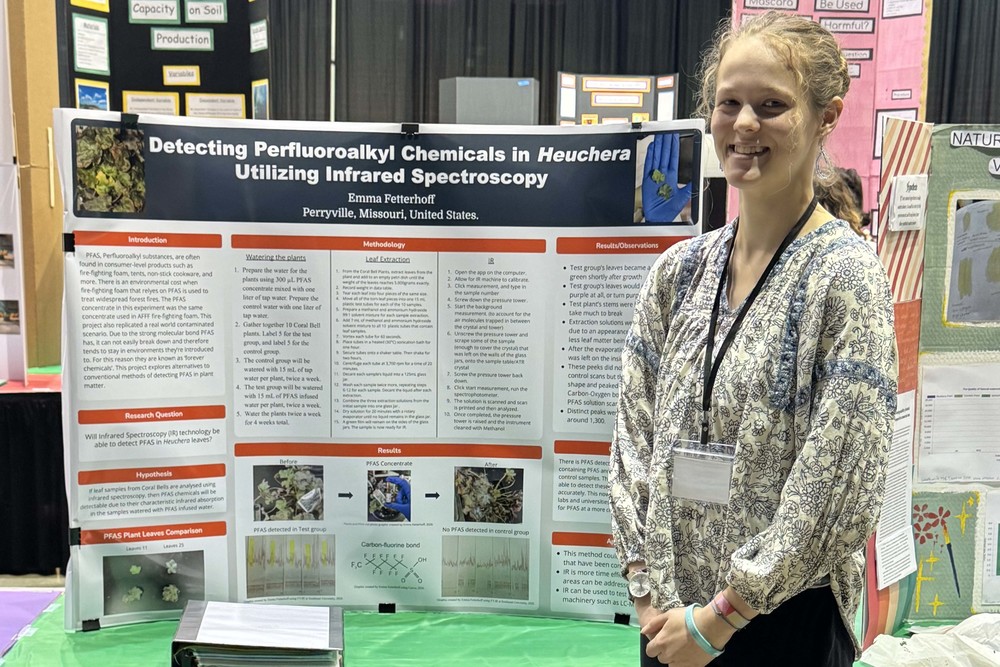 Emma Fetterhoff stands next to her science fair project.