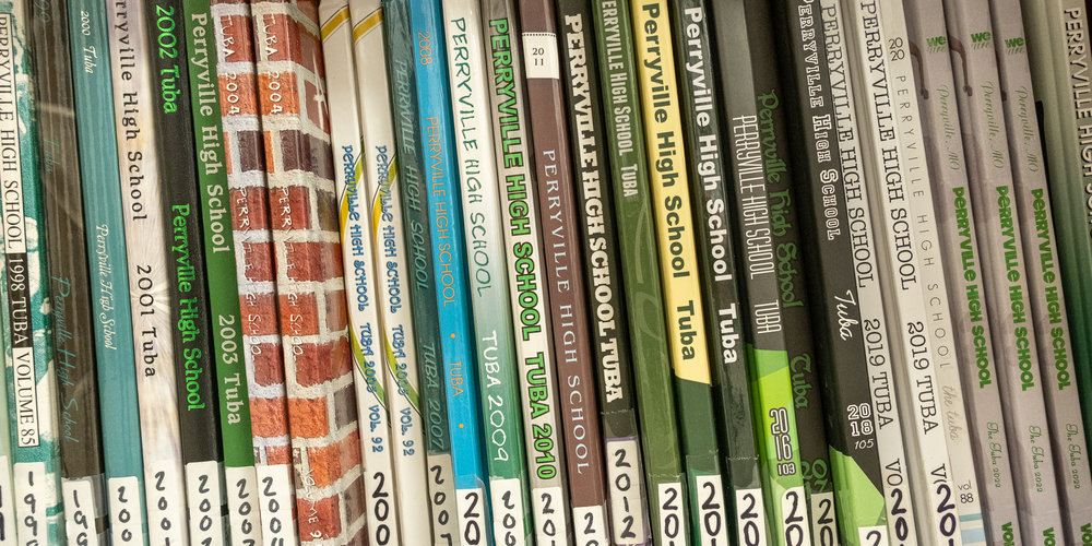 A closeup shot of a row of PHS yearbooks sitting on a shelf spanning several years from 1998 to 2023