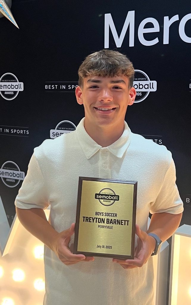 Treyton Barnett holding his Semoball boys soccer athlete of the year plaque