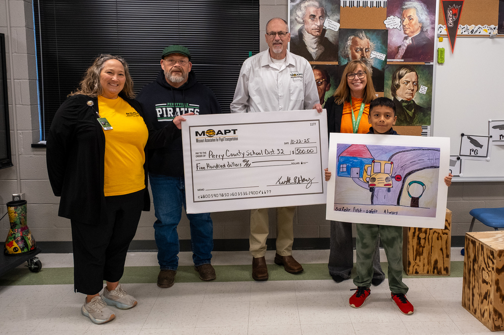 Group photo of District 32 Transportation Director Sarah Orf, Assistant Director Donald Gwinn, MAPT Executive Director Keith Henry, PES Principal Dr. Amy Dill and PES 3rd grader Nicholas Hernandez Pastor.
