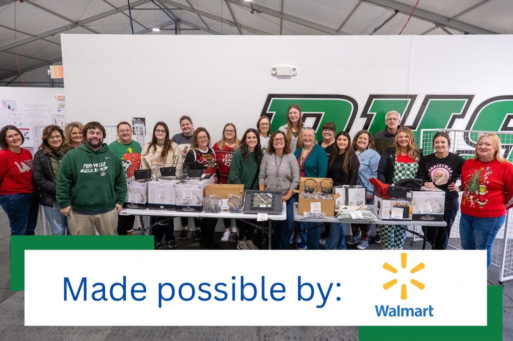 PHS teachers pose alongside Parent Anchor Initiative members behind a table of supplies that were purchased through a grant from Walmart.