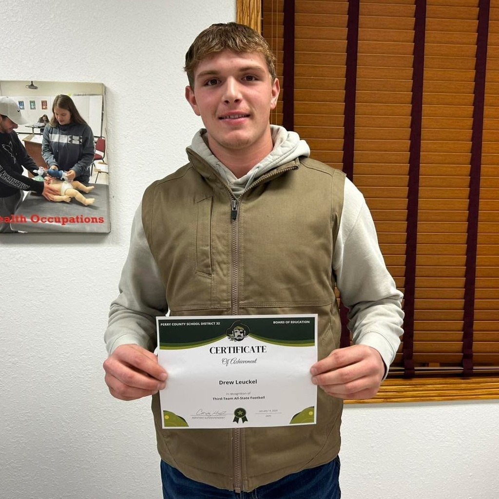 Drew Leuckel poses holding his board recognition certificate.