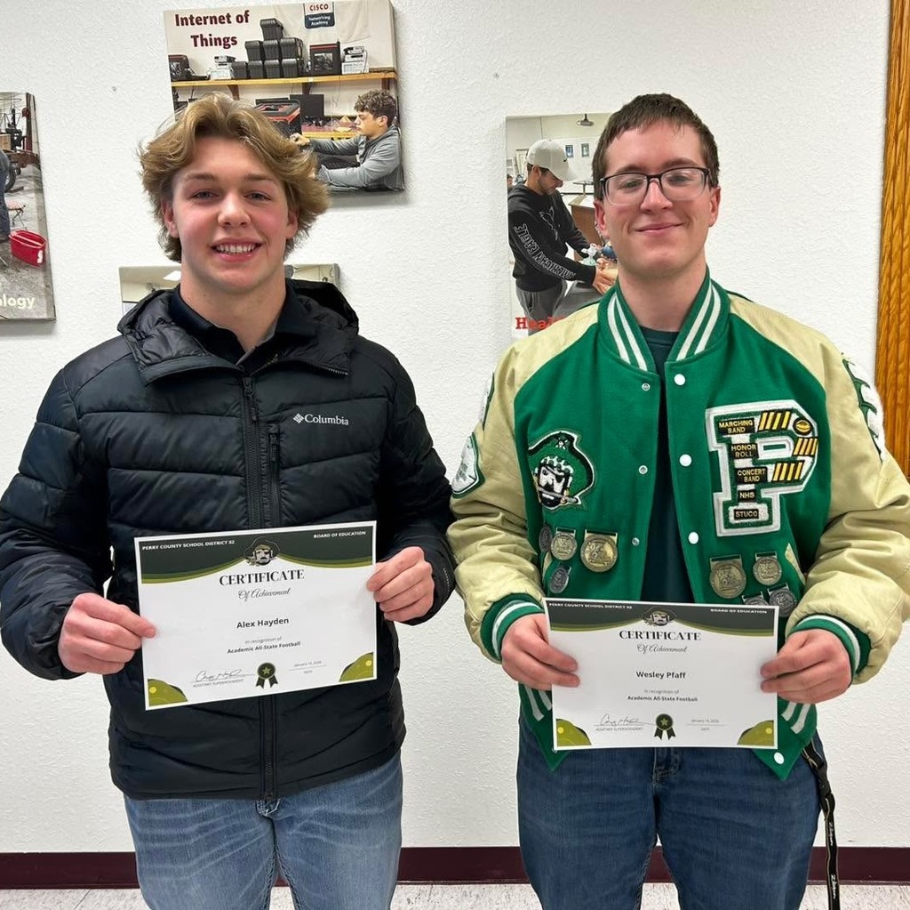 Alex Hayden and Wesley Pfaff pose holding their recognition certificates.