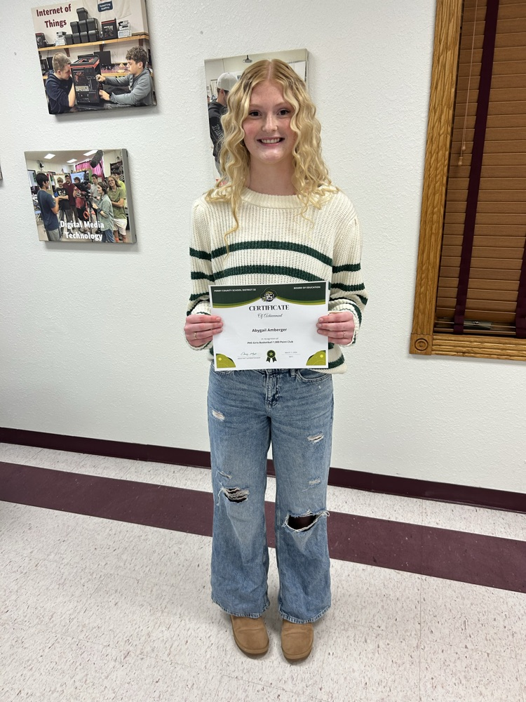 PHS junior Aby Amberger holding a certificate 