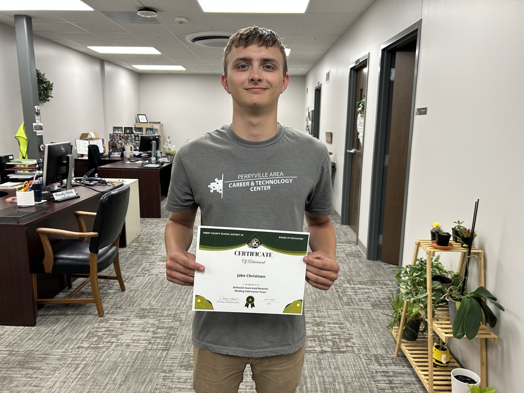 Jake Christisen holds a certificate.