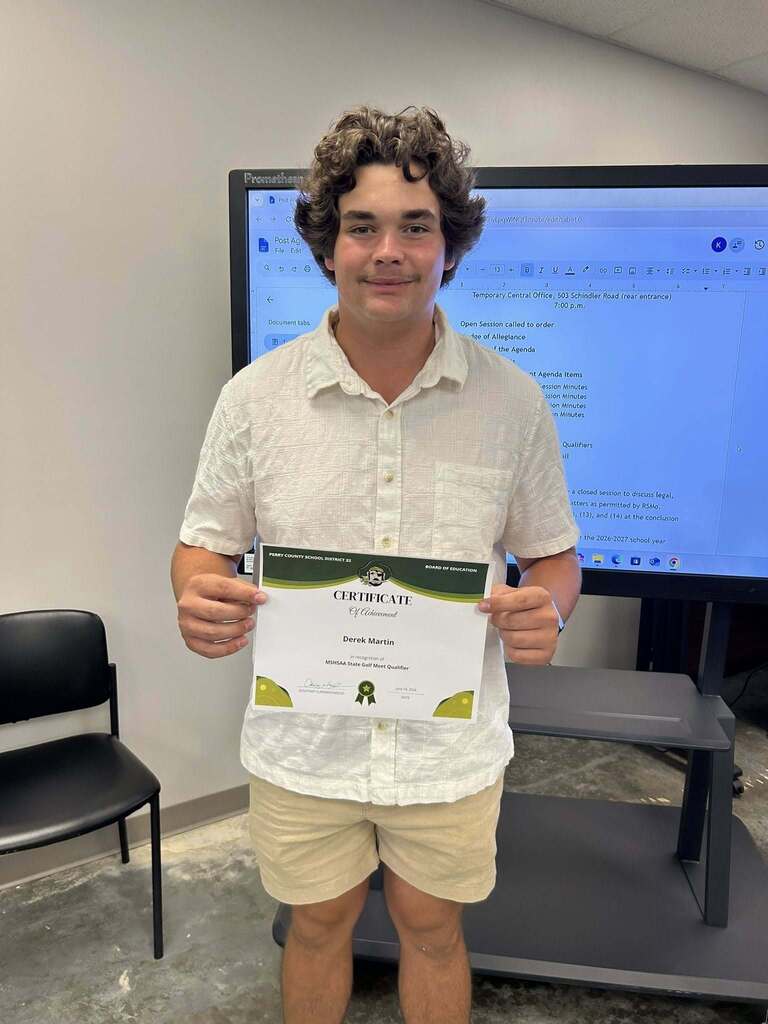 Derek Martin holding a certificate