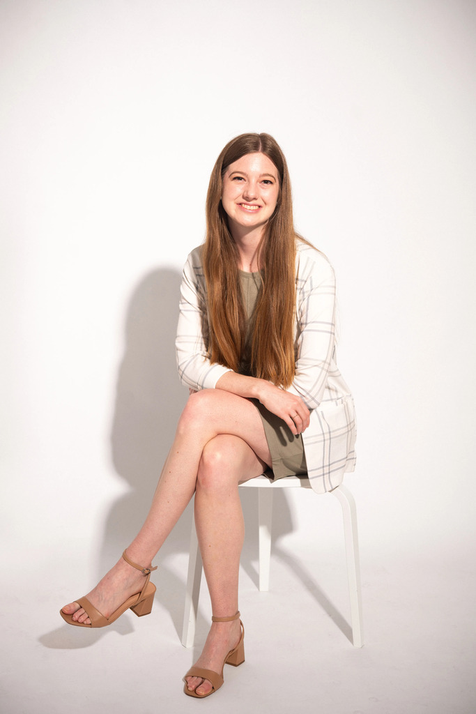 Phoebe Pohlman sits on a white stool in front of a white background for her 2026 Difference Maker photo. Photo by Aaron Eisenhauer of the Southeast Missourian.