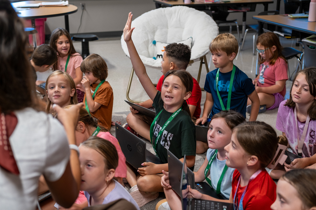 A student raises her hand.