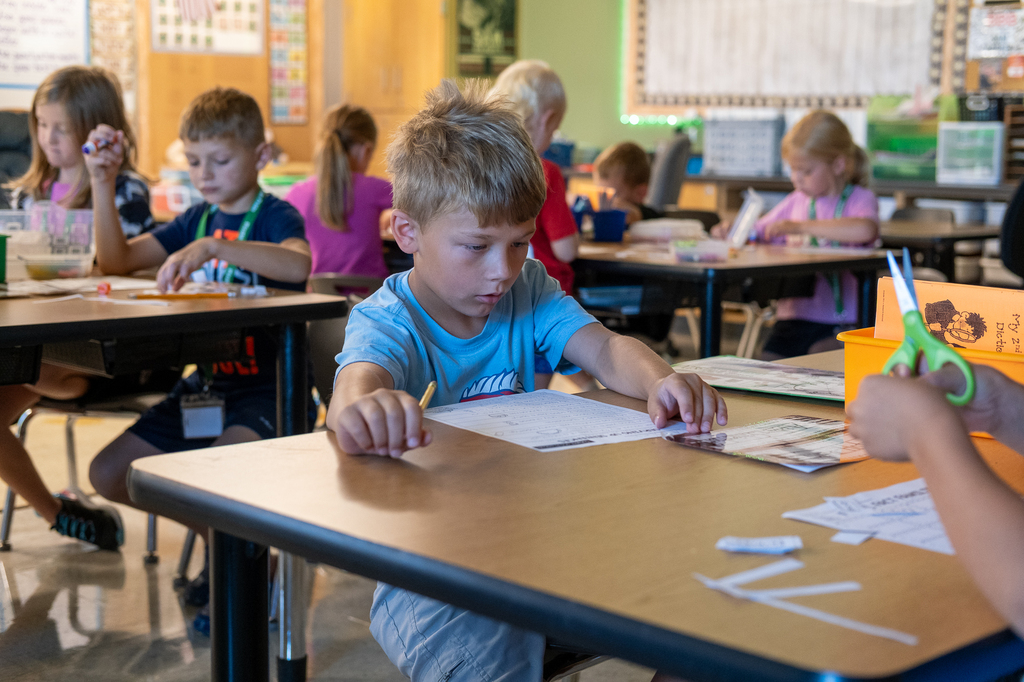A student works on a worksheet at his desk.