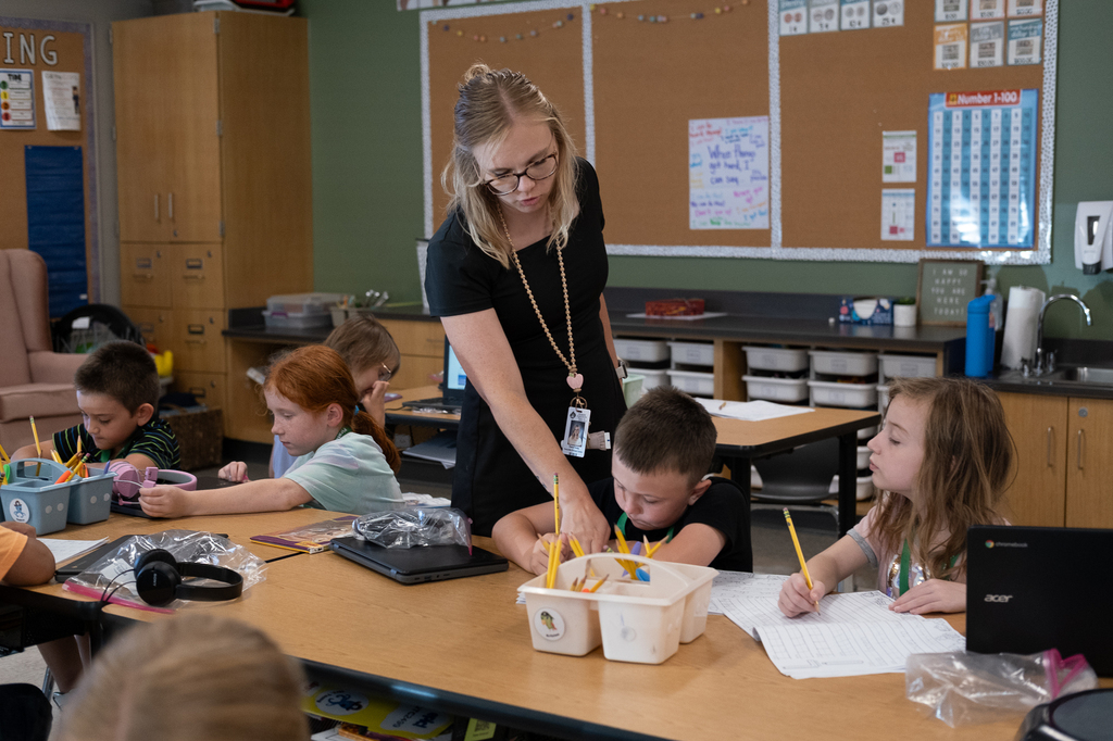 A teacher helping a student.