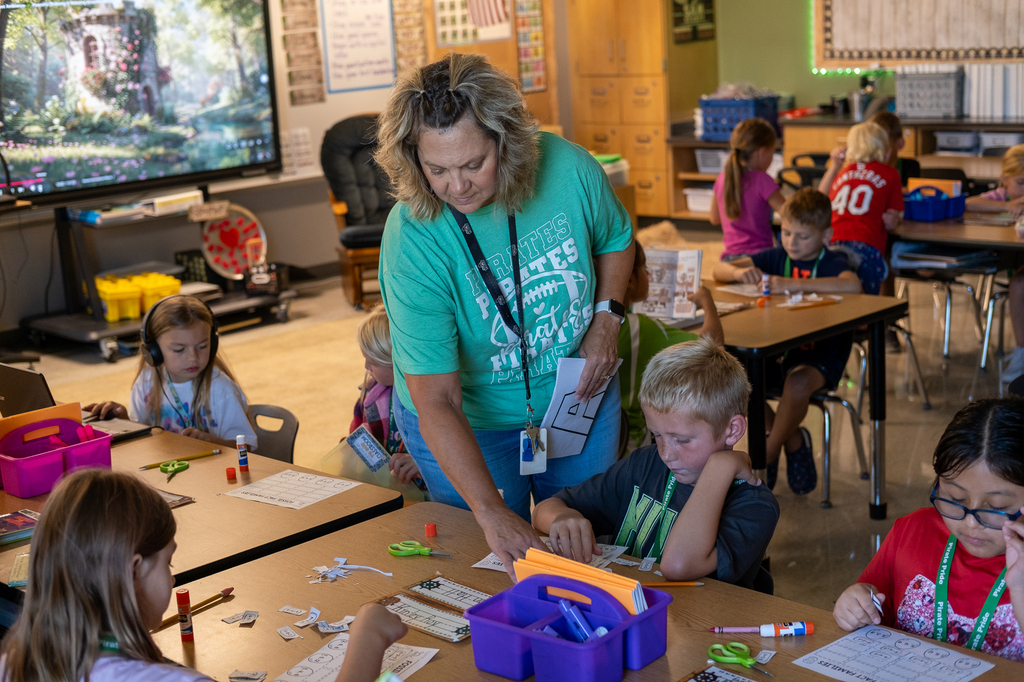 A teacher assists a student.