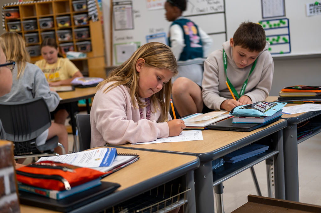 Two students work on a worksheet.