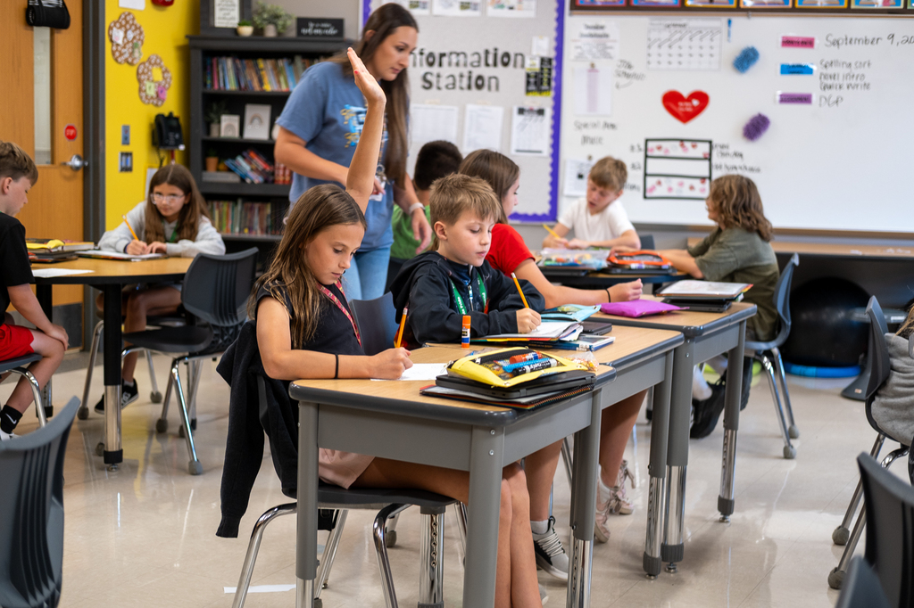 Student raises her hand in class.